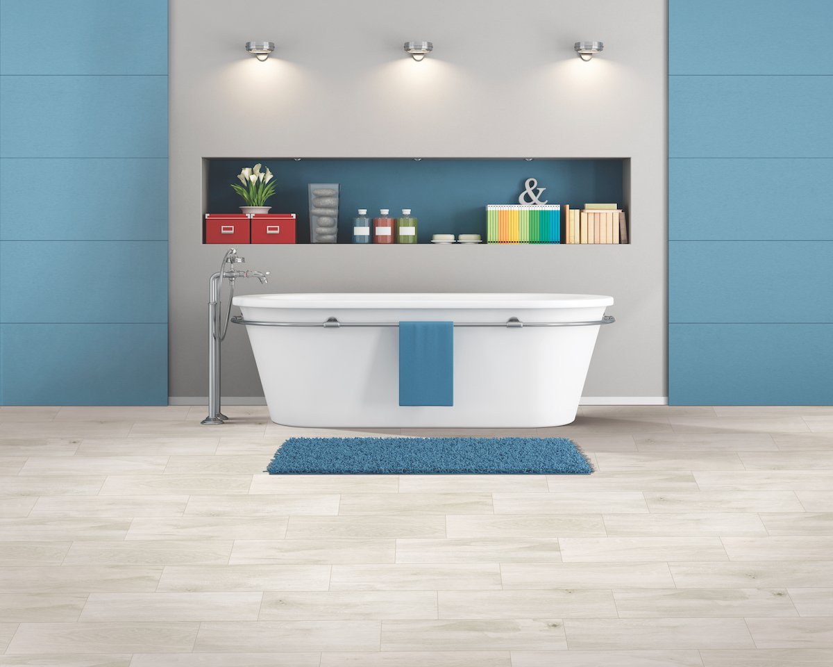 Modern spacious bathroom with free standing bathtub and blue mat